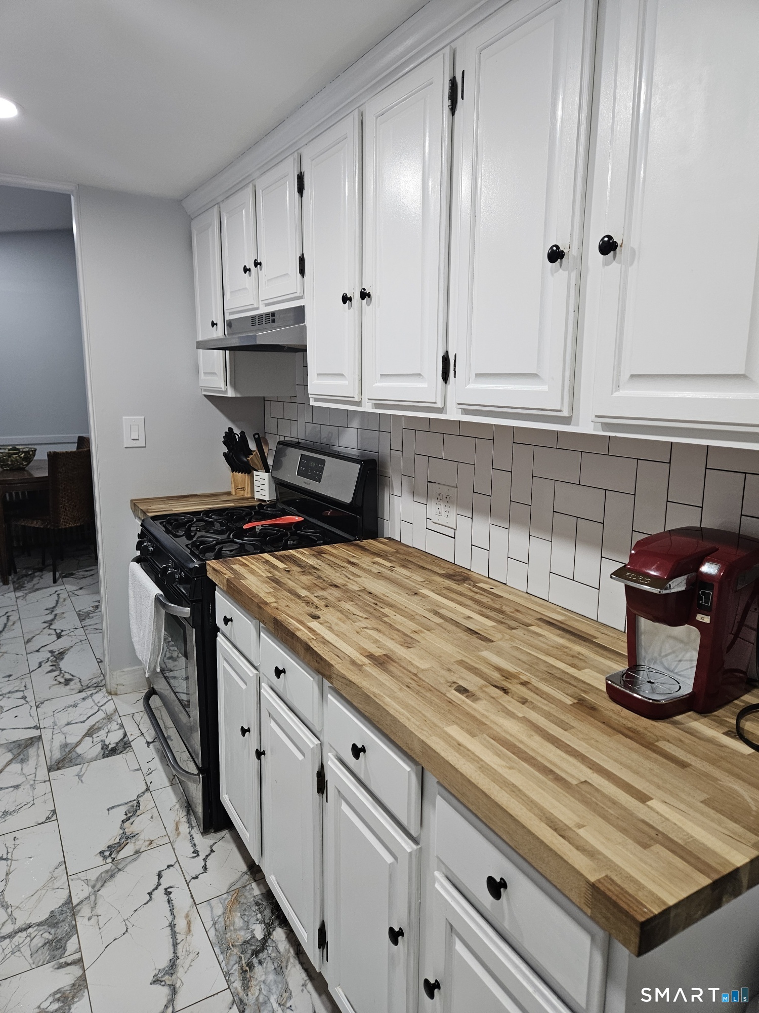 901 Baldwin Road Woodbridge, CT 06525 - Photo 16 of 27 a kitchen with granite countertop a sink a stove and cabinets