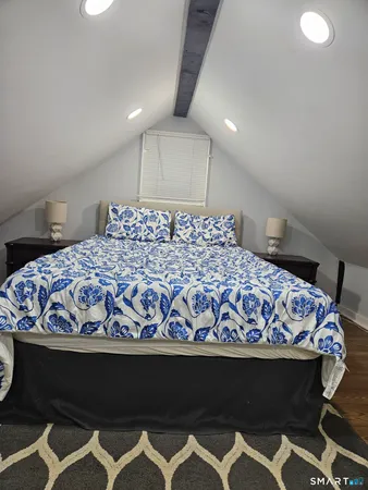 a bedroom with a bed and a window