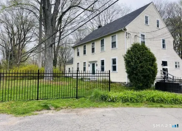 a view of a house with a garden and plants