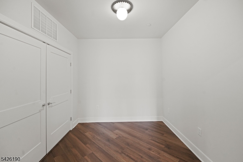 434 Springfield Avenue Berkeley Heights, NJ 07922 - Photo 24 of 24 a view of an empty room with wooden floor