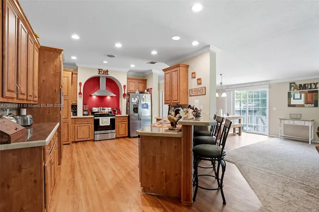 a dining hall with furniture and a large window