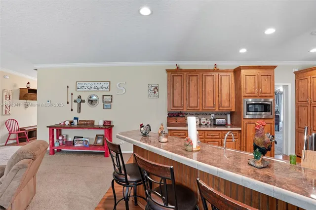 a kitchen view of a stove a sink and a refrigerator