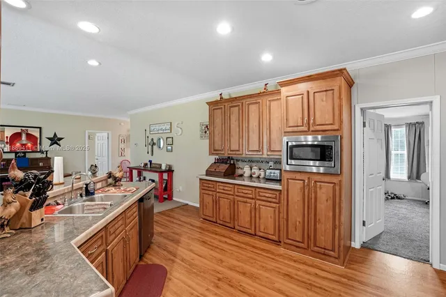 a kitchen with a sink and wooden floor