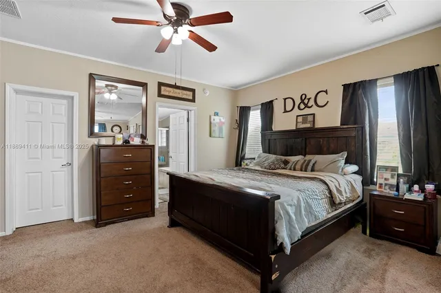 a spacious bedroom with a bed and a chandelier