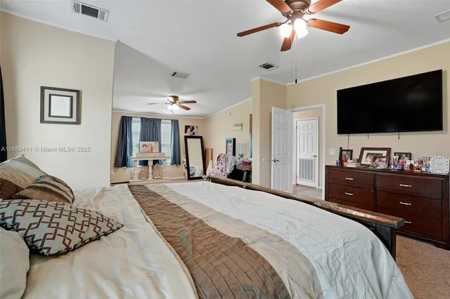 a spacious bedroom with a bed and a chandelier