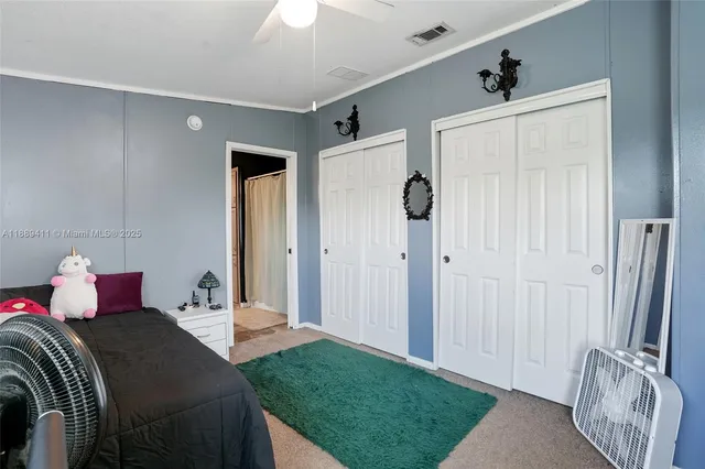 a bedroom with bed and a large window