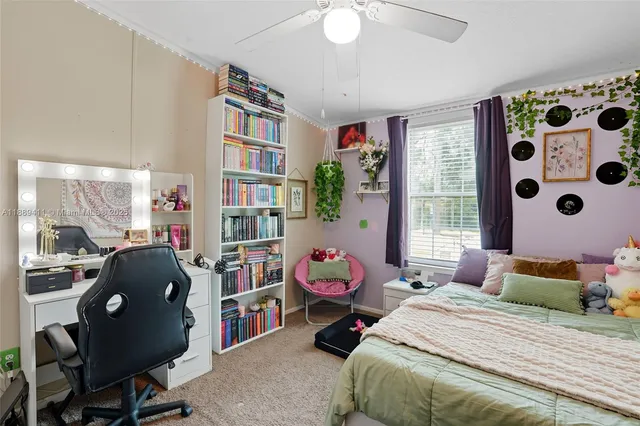 a bedroom with a bed and a flat tv screen