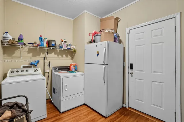 a view of a green field with wooden fence