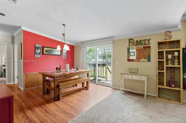 a living room with furniture a fireplace and a chandelier
