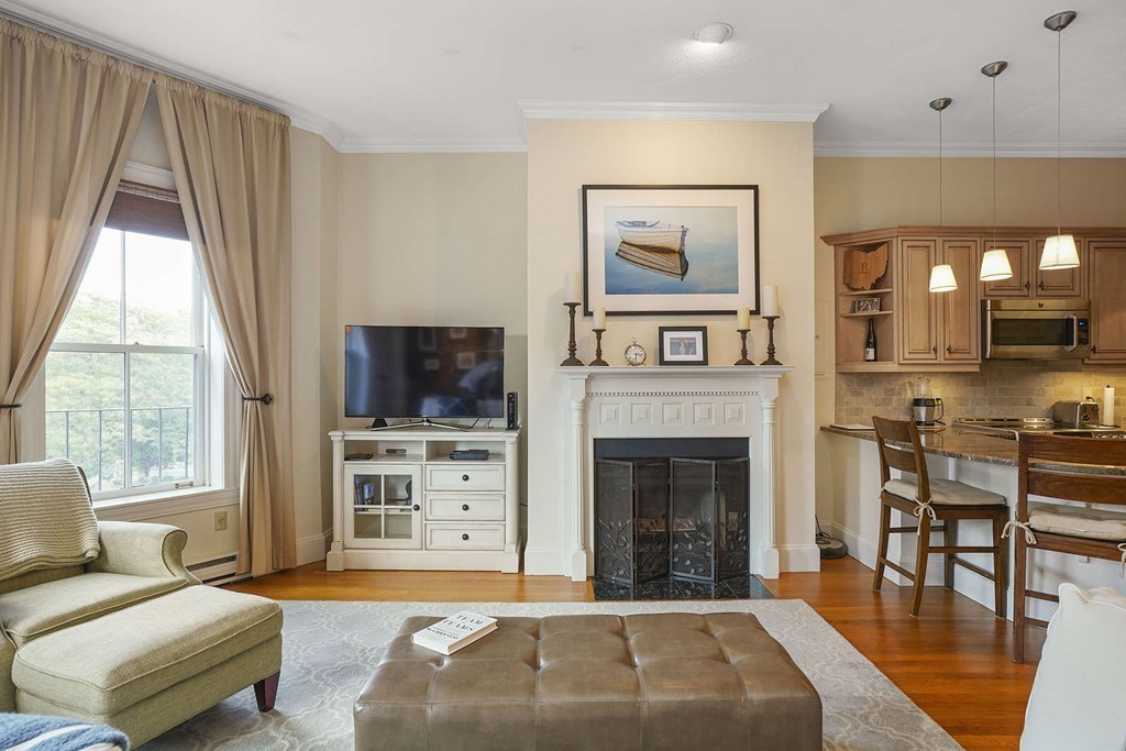 6 Columbus Square, Unit 3 Boston, MA 02116 - Photo 2 of 16 a living room with furniture a flat screen tv and a fireplace