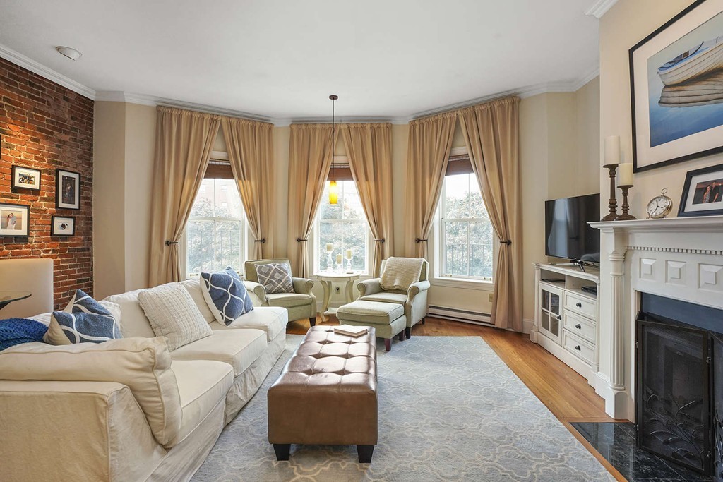 6 Columbus Square, Unit 3 Boston, MA 02116 - Photo 4 of 16 a living room with furniture a fireplace and a large window