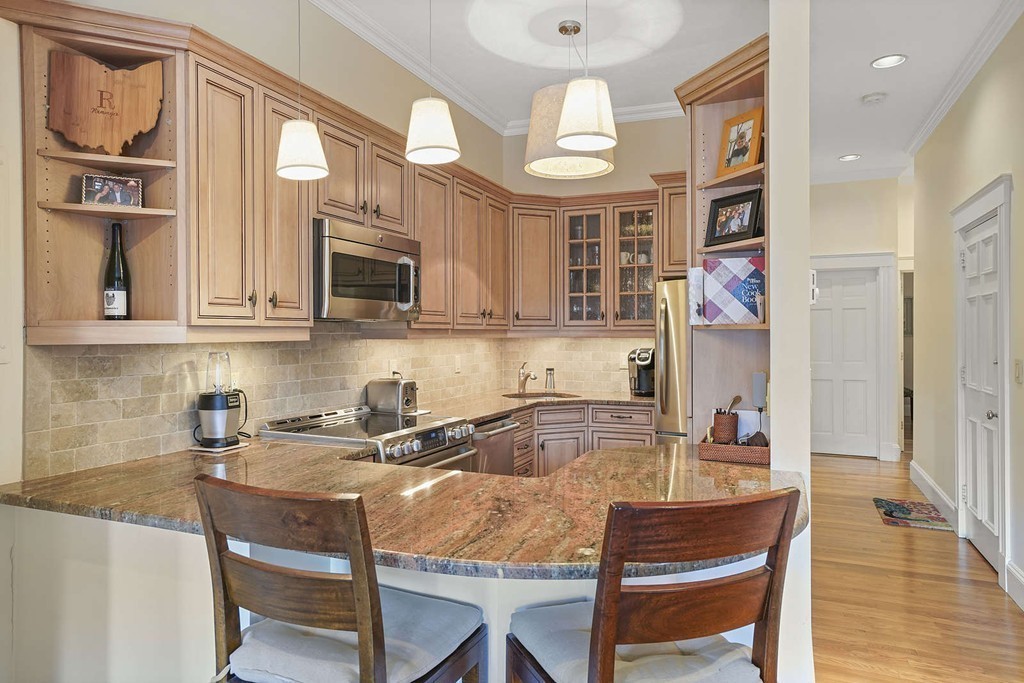 6 Columbus Square, Unit 3 Boston, MA 02116 - Photo 6 of 16 a kitchen with stainless steel appliances granite countertop a sink and a refrigerator