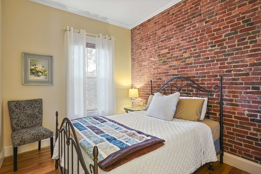 6 Columbus Square, Unit 3 Boston, MA 02116 - Photo 10 of 16 a bedroom with a bed and wooden floor