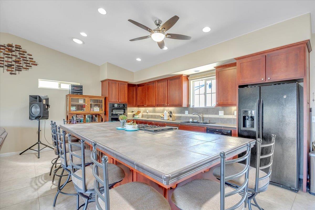 411 Sunrise Road Copperopolis, CA 95228 - Photo 23 of 76 Beautiful tilework and cherry cabinetry. Refrigerator, wine fride, Jenn-Aire range and more!