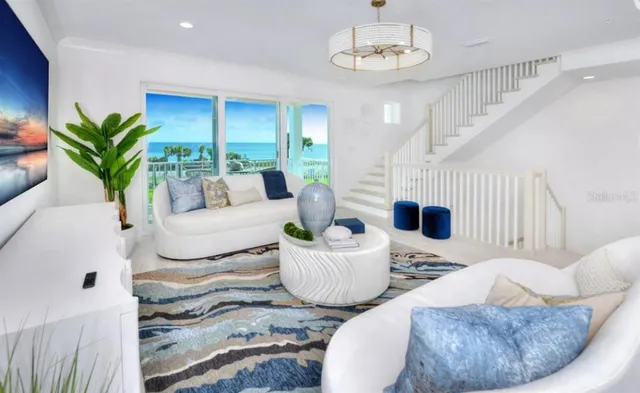 a living room with fireplace furniture and a chandelier