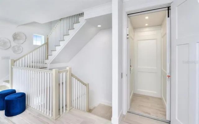 a view of staircase with white walls and railing