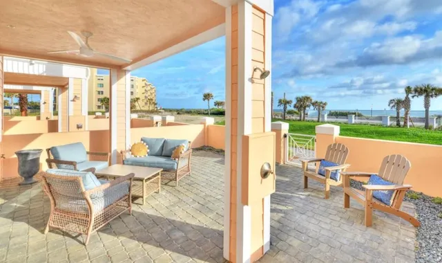 a view of living room with patio furniture and a yard