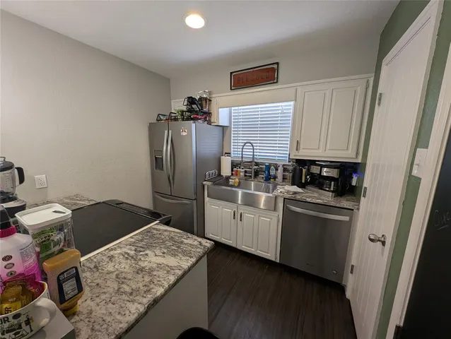 a kitchen with stainless steel appliances granite countertop a refrigerator and a stove