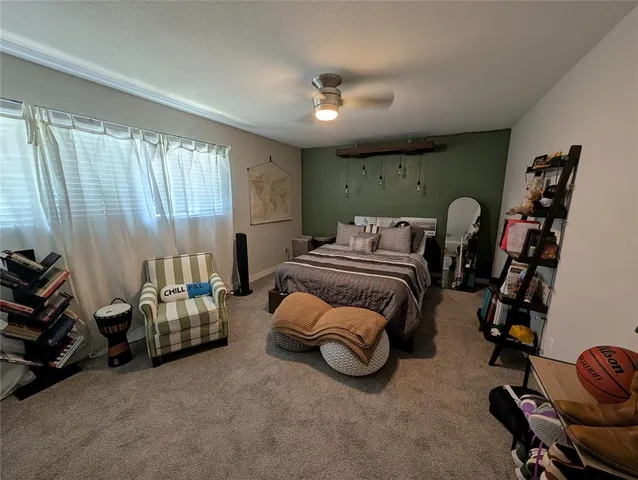 a bedroom with bed and a chandelier