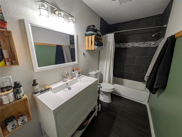 a bathroom with a sink mirror toilet and bathtub