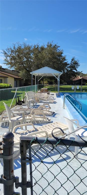 2218 Abbey Road Southwest Winter Haven, FL 33880 - Photo 28 of 31 a view of house with backyard entertaining space and outdoor seating