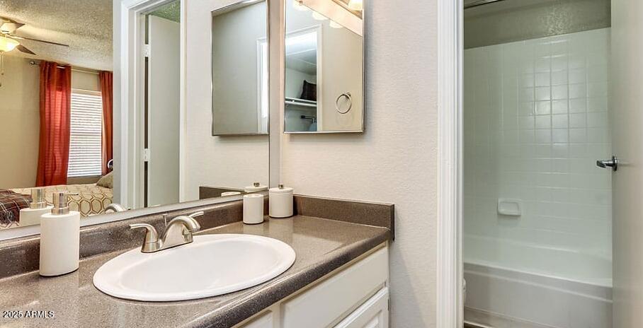 445 South Dobson Road, Unit A2 Mesa, AZ 85202 - Photo 4 of 7 a bathroom with a granite countertop sink and a mirror