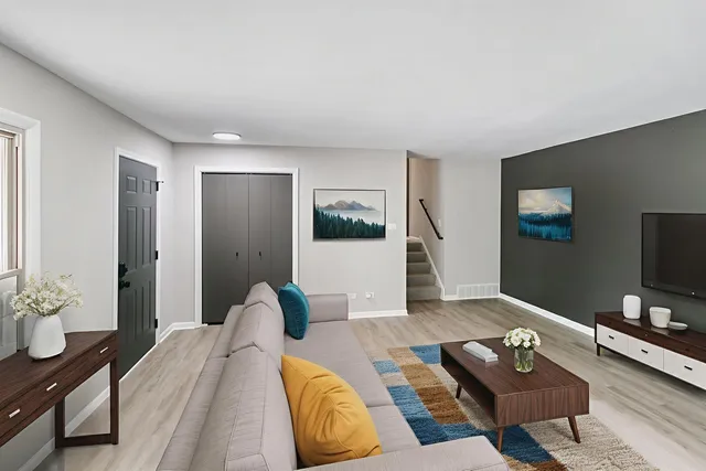 a bedroom with furniture and a flat screen tv