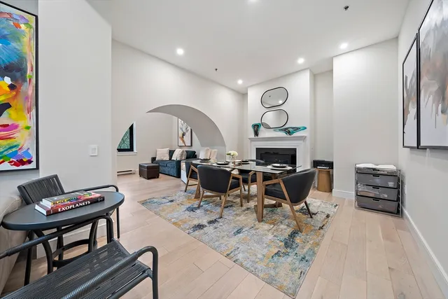 a living room with furniture a rug and a chandelier