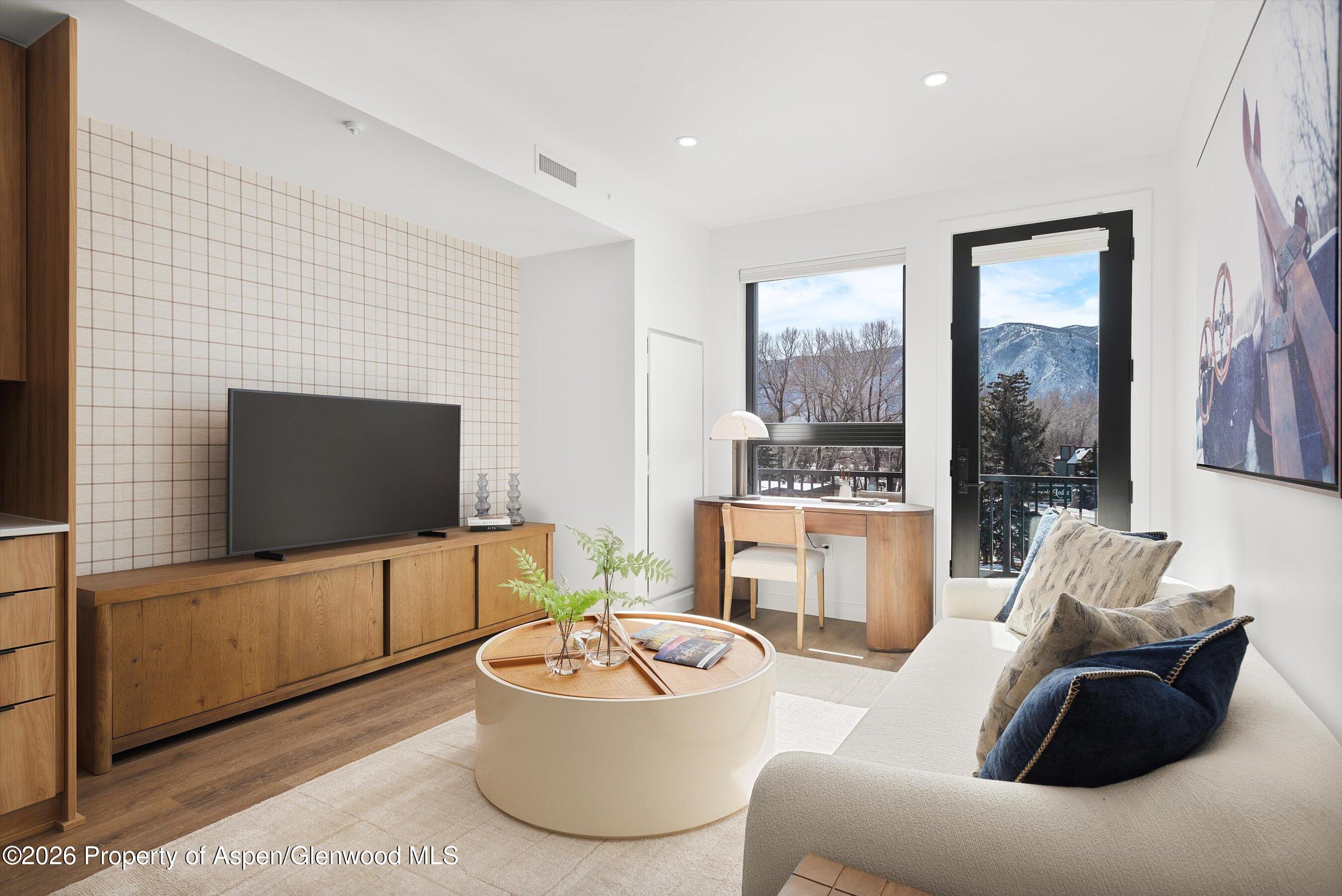 140 Basalt Center Circle, Unit 322 Basalt, CO 81621 - Photo 2 of 24 a living room with furniture and a flat screen tv