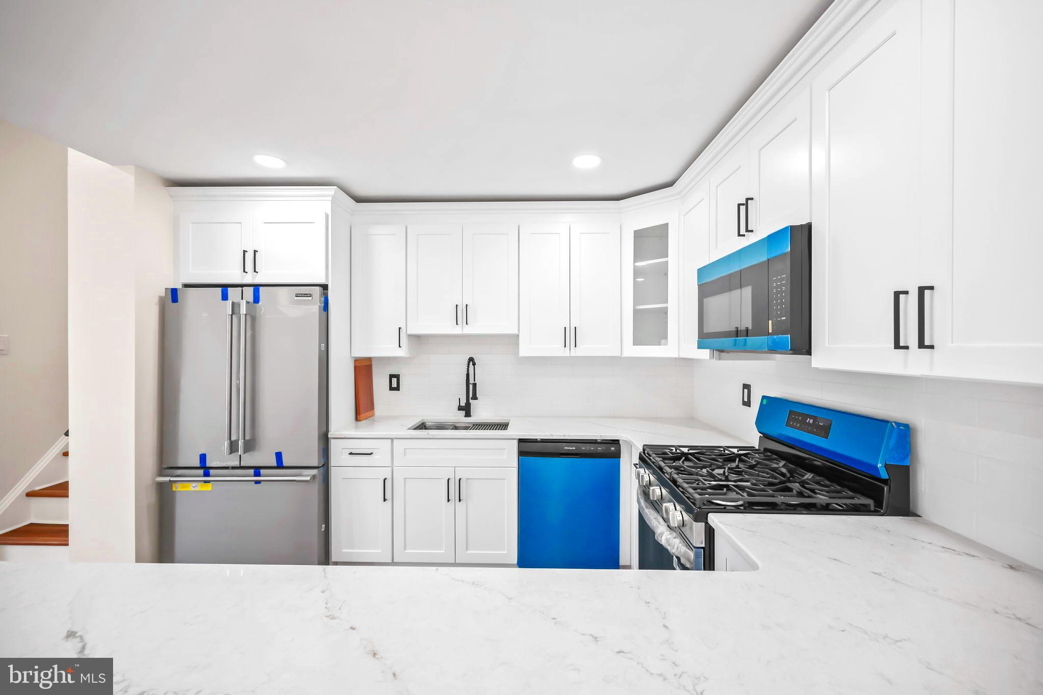 61 Argonne Avenue Hamilton, NJ 08620 - Photo 11 of 38 a kitchen with stainless steel appliances granite countertop a refrigerator and a stove top oven