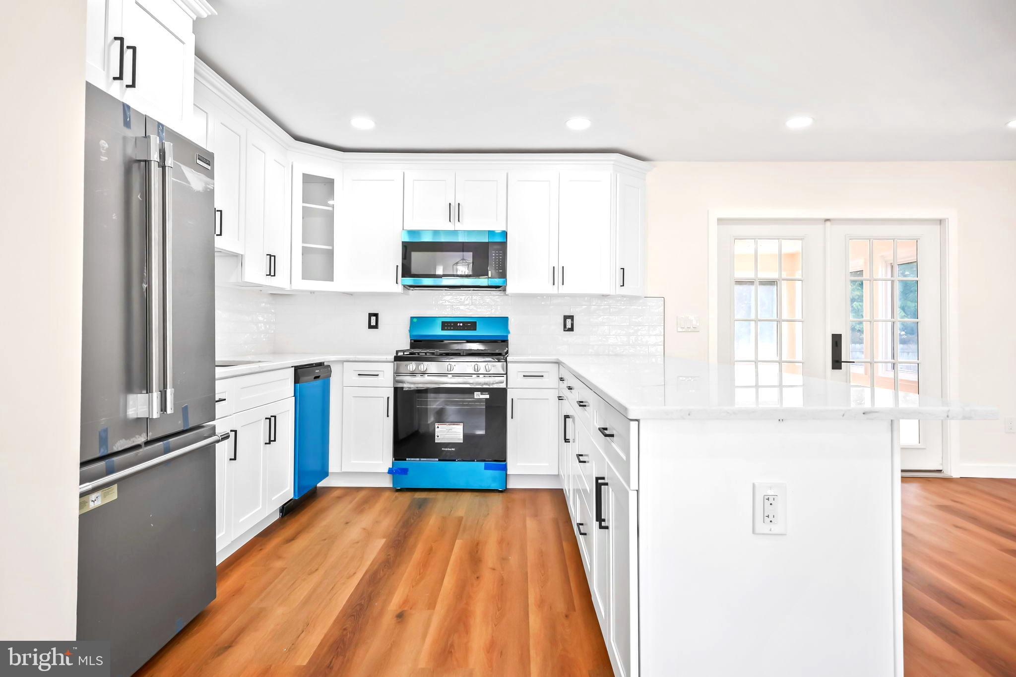 61 Argonne Avenue Hamilton, NJ 08620 - Photo 12 of 38 a kitchen with stainless steel appliances a refrigerator sink and cabinets