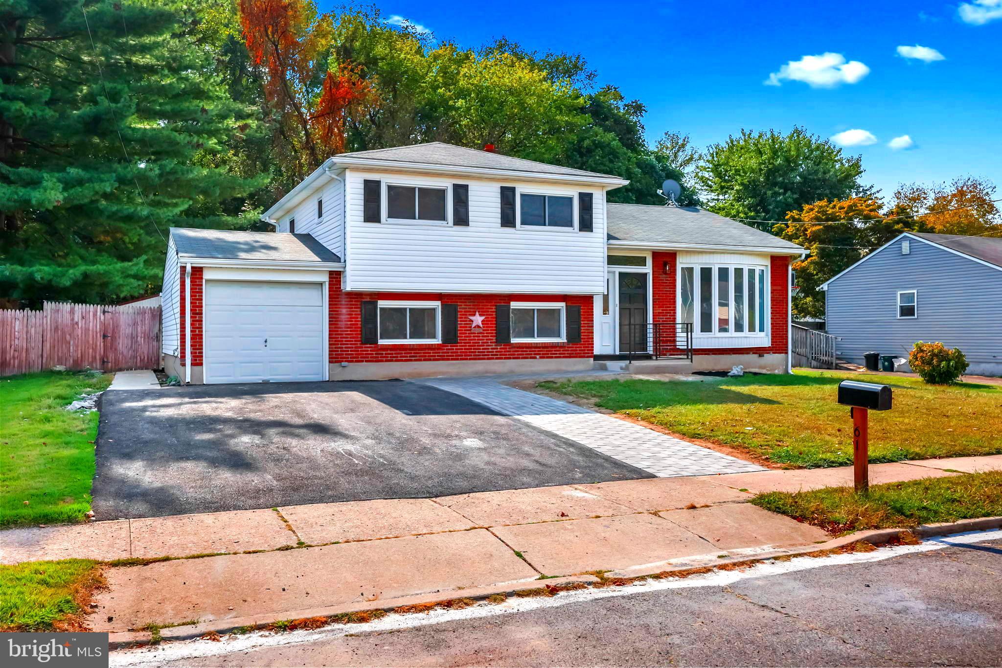 61 Argonne Avenue Hamilton, NJ 08620 - Photo 2 of 38 a front view of a house with a yard and garage
