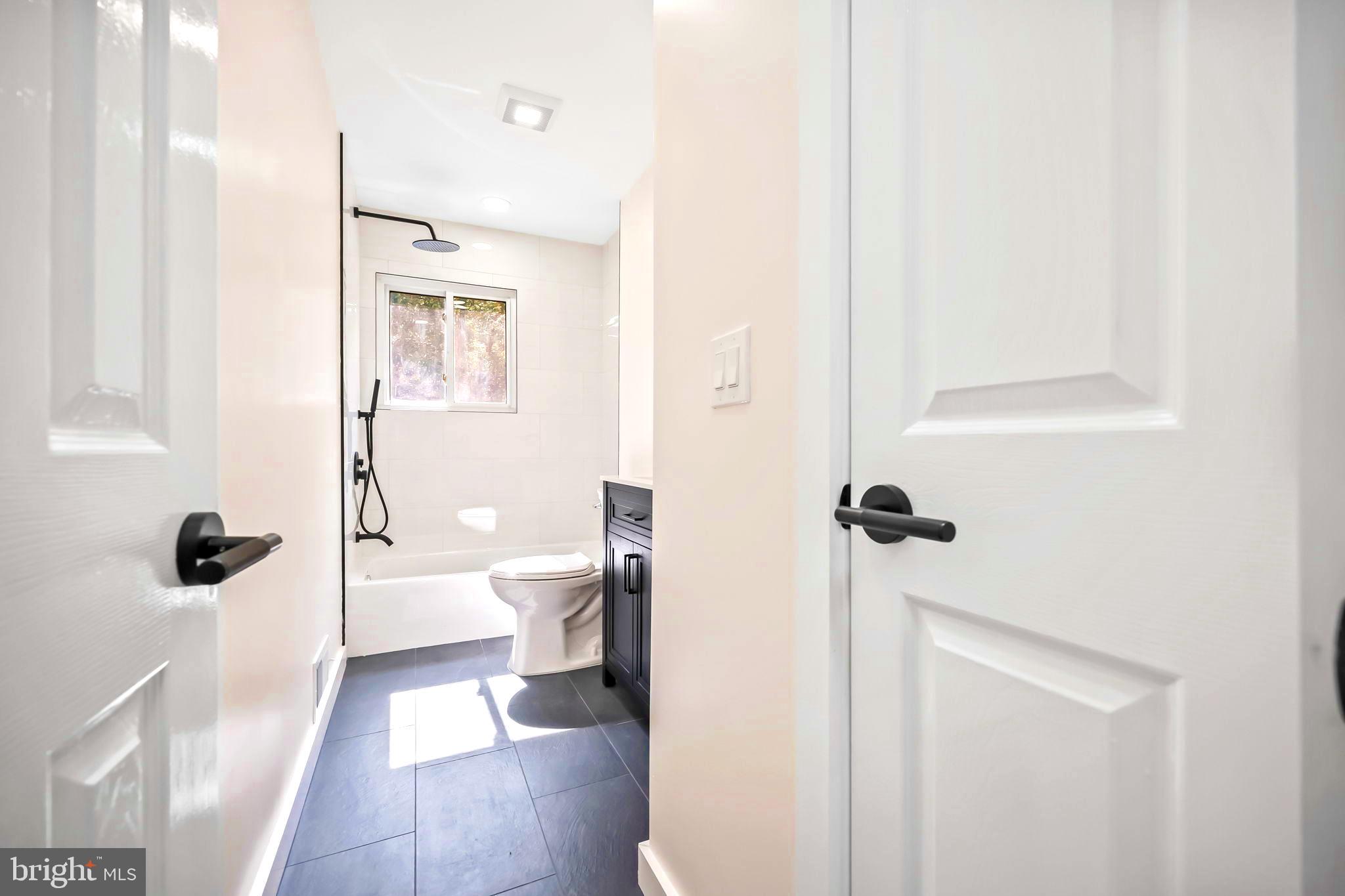 61 Argonne Avenue Hamilton, NJ 08620 - Photo 21 of 38 a bathroom with a sink a toilet and shower
