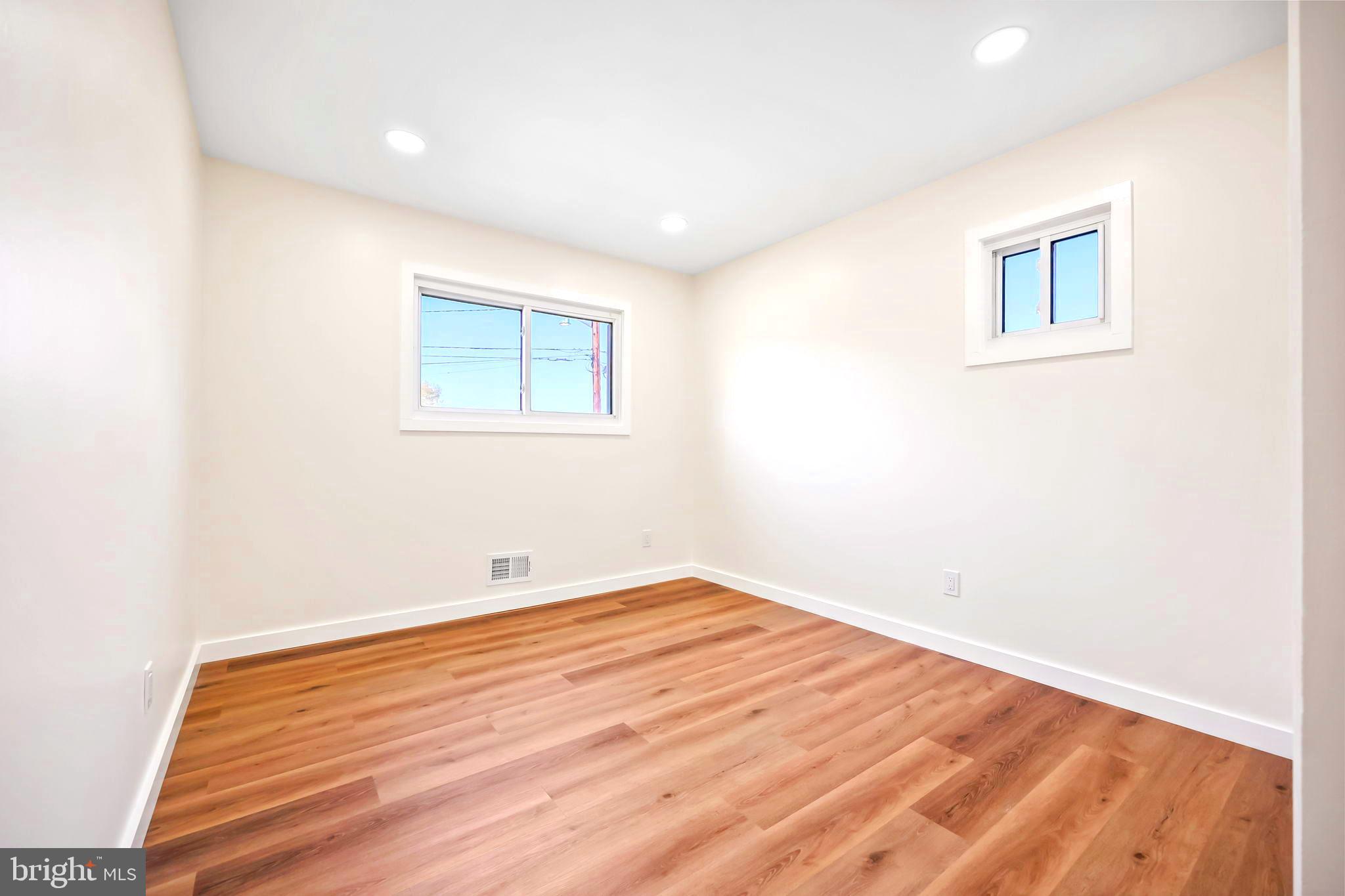 61 Argonne Avenue Hamilton, NJ 08620 - Photo 25 of 38 an empty room with wooden floor and windows