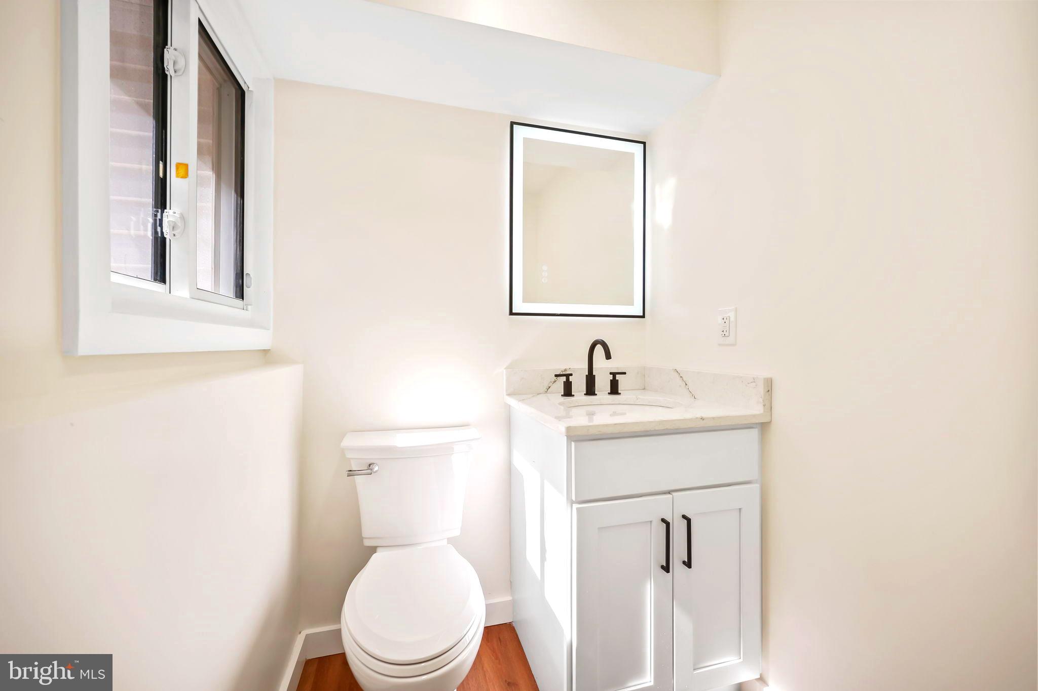 61 Argonne Avenue Hamilton, NJ 08620 - Photo 31 of 38 a bathroom with a toilet a sink and mirror