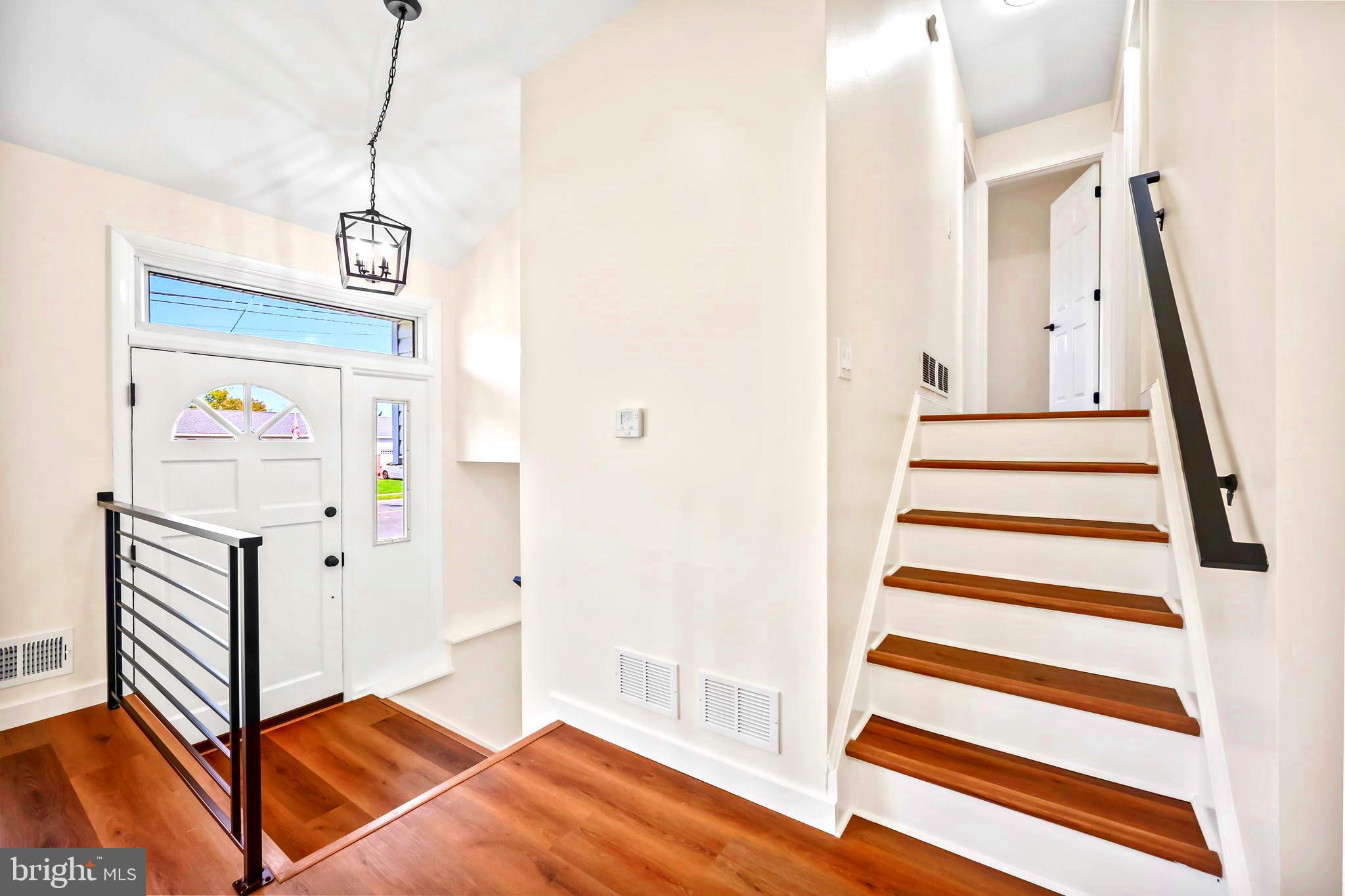 61 Argonne Avenue Hamilton, NJ 08620 - Photo 4 of 38 a view of a hallway with stairs and a chandelier
