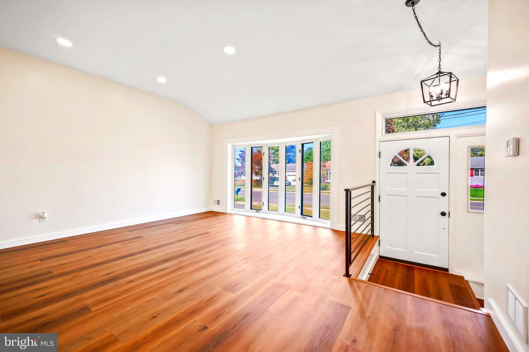 61 Argonne Avenue Hamilton, NJ 08620 - Photo 8 of 38 a view of an empty room with wooden floor and windows