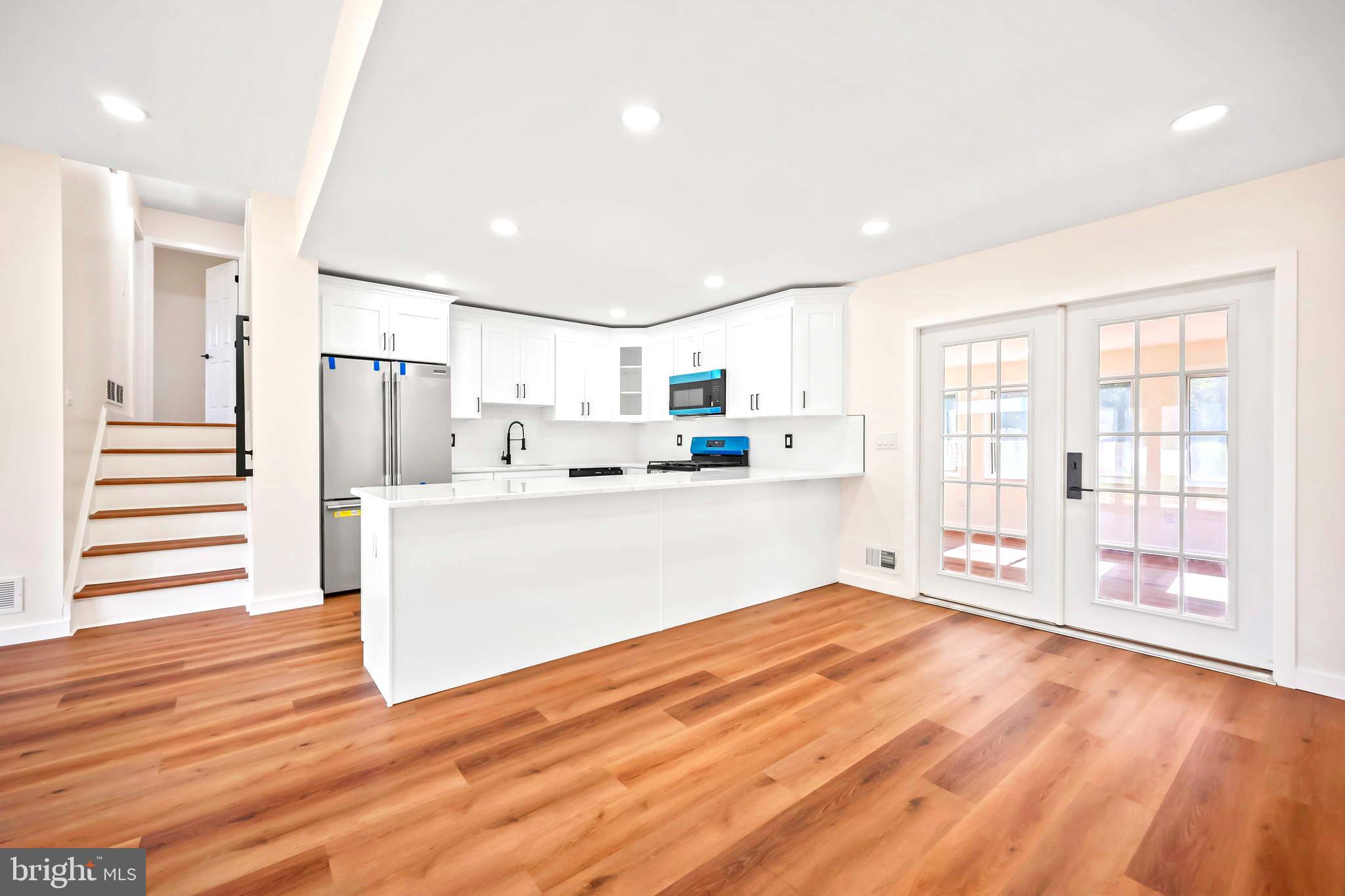 61 Argonne Avenue Hamilton, NJ 08620 - Photo 9 of 38 a kitchen with stainless steel appliances refrigerator cabinets and wooden floor