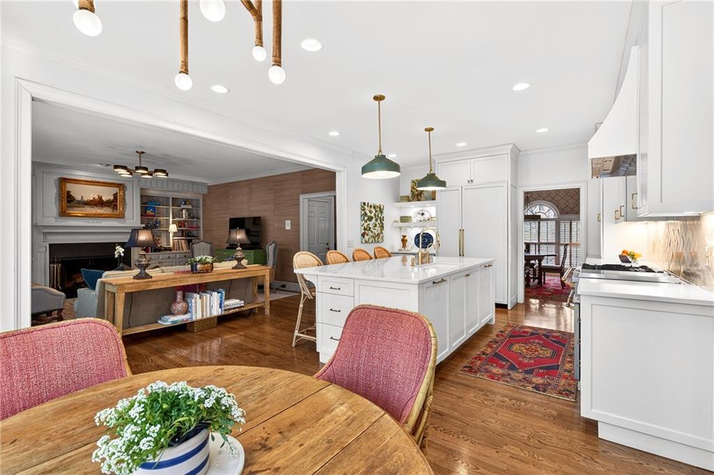 3642 Mayfair Road Northeast Atlanta, GA 30305 - Photo 12 of 40 a living room with kitchen island furniture and a kitchen view