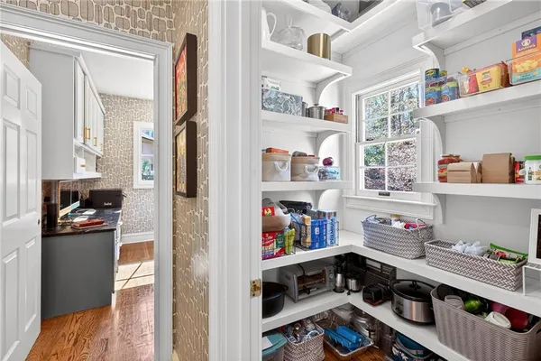 a kitchen with a refrigerator and a stove top oven