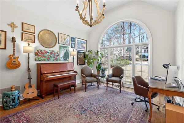 a living room with furniture a rug and a large window