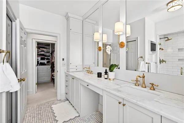 a bathroom with a double vanity sink a mirror and a shower