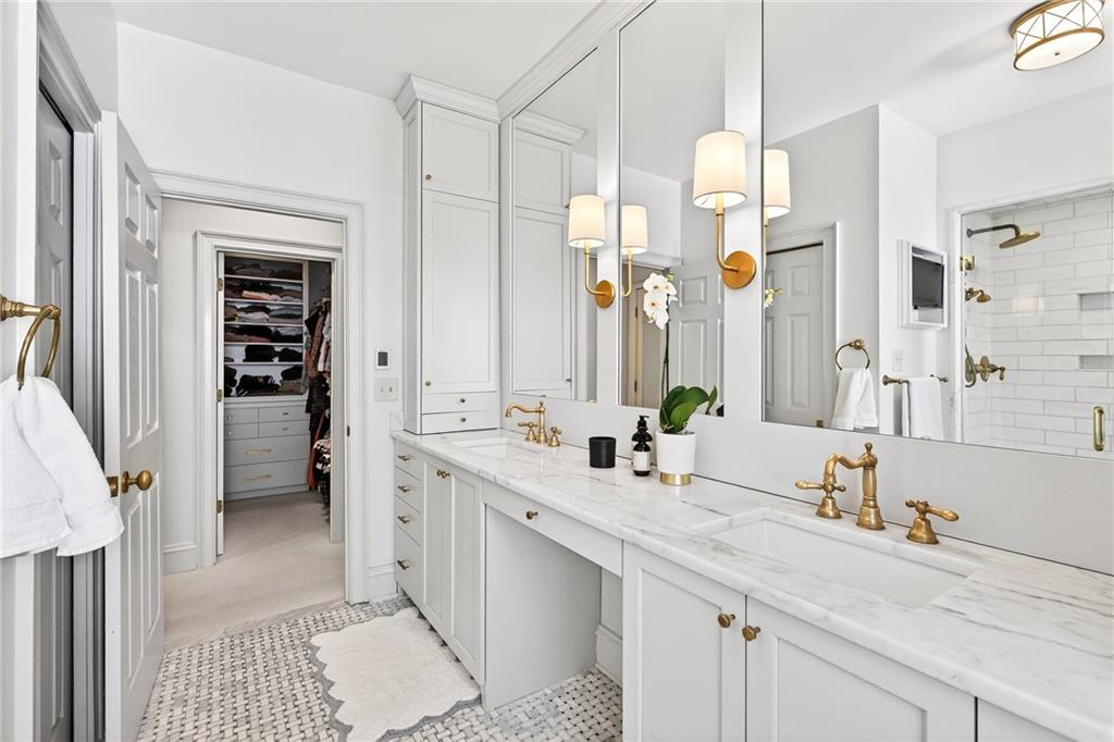 3642 Mayfair Road Northeast Atlanta, GA 30305 - Photo 21 of 40 a bathroom with a double vanity sink a mirror and a shower
