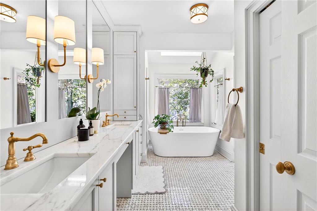 3642 Mayfair Road Northeast Atlanta, GA 30305 - Photo 22 of 40 a bathroom with a sink a faucet a potted plant and a mirror