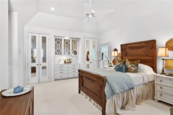 a bedroom with a bed and a large mirror