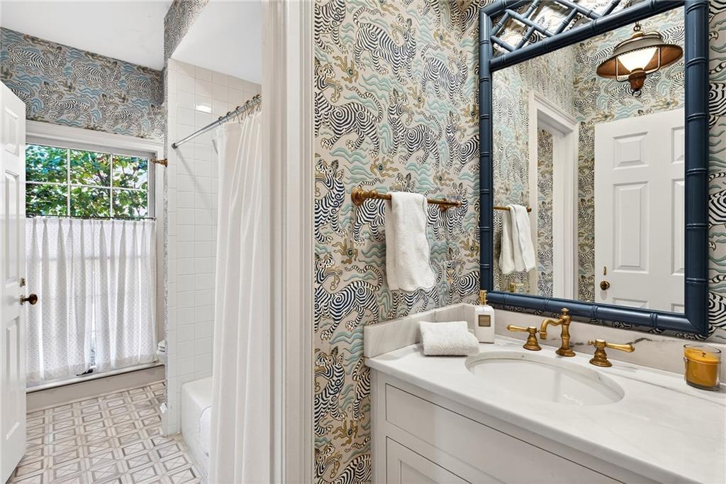 3642 Mayfair Road Northeast Atlanta, GA 30305 - Photo 26 of 40 a bathroom with a sink and a mirror