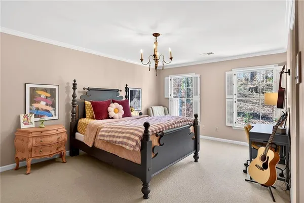 a bedroom with a bed and a chandelier