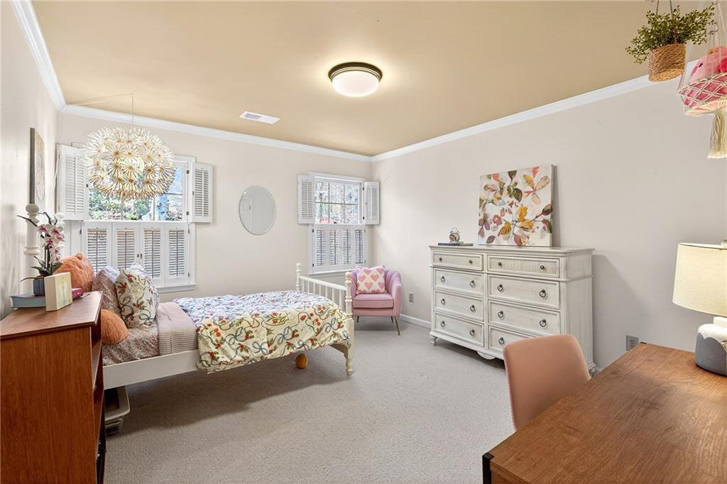 3642 Mayfair Road Northeast Atlanta, GA 30305 - Photo 30 of 40 a bedroom with a bed and wooden floor