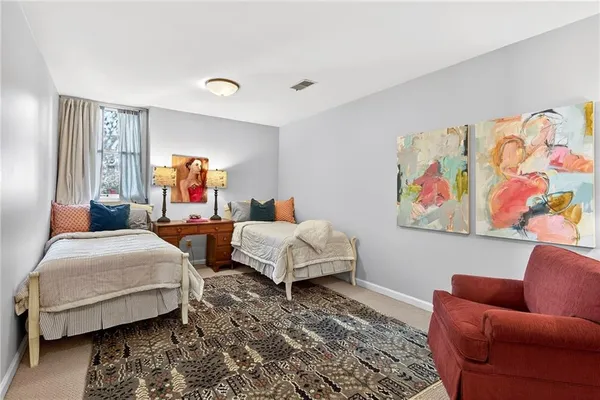 a bedroom with bed couch and window