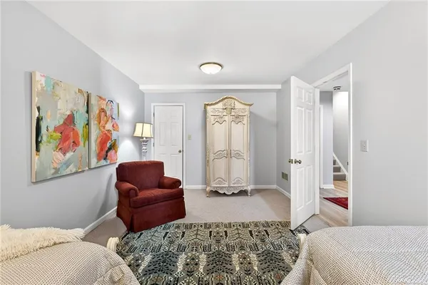 a bedroom with furniture and a rug